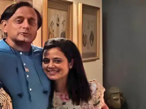 Congress MP Shashi Tharoor and TMC MP Mahua Moitra standing together.